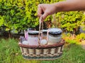 Someone& x27;s hand holds a basket filled with overnight oats in a jar