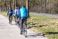 Someren, North Brabant, Netherlands. February 27, 2022. Group of cyclists pedaling on a cycle path parallel to a countryside road Royalty Free Stock Photo