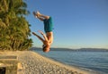 Athletic Man doing a somersault on a beach Royalty Free Stock Photo