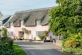 A  thatched roof pink cottage in a typical English village Royalty Free Stock Photo