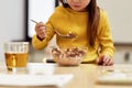 Something crispy and crunchy. Cropped shot of caucasian cute little girl eating cereal balls with milk for her breakfast Royalty Free Stock Photo