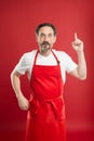 Something new. Cook with beard and mustache wearing apron red background. Man mature cook posing cooking apron. Chief
