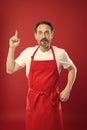 Something new. Cook with beard and mustache wearing apron red background. Man mature cook posing cooking apron. Chief