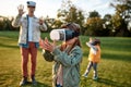 Something new. Family playing in virtual reality glasses outdoors
