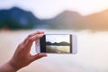 Somethings demand a photograph. a young woman taking photographs at the beach.