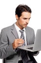 Somethings gone wrong. A focused young executive working on his laptop while isolated on white. Royalty Free Stock Photo