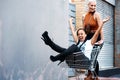 Sometimes all you need is a trolley to be happy. two cheerful young girlfriends having fun with a shopping cart outdoors