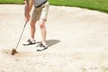 Sometimes golfing gets a little tricky. Senior man trying to hit his ball out of the sandtrap on the golf course. Royalty Free Stock Photo