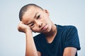 Sometimes Im sad and I dont know why. Studio shot of a cute little boy looking bored against a grey background.