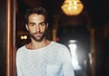 Sometimes the simplest clothing is the best kind. Portrait of a handsome man dressed in casual wear posing in a doorway.