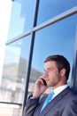 Sometimes you have to run away for some privacy. a handsome young businessman talking on his mobile phone at work. Royalty Free Stock Photo