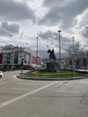 Somewhere street with statue in middle street