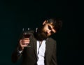 Sommelier with beard on dark emerald background