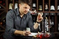 Sommelier looking at red wine glass with beverage Royalty Free Stock Photo