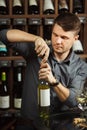 Sommelier opening white wine bottle with corckcrew Royalty Free Stock Photo