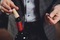 Sommelier man sniffing cork of red wine bottle corkscrew Royalty Free Stock Photo