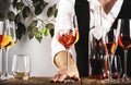 Sommelier pouring rose wine into glass at wine tasting in winery, bar or restaurant. White background Royalty Free Stock Photo