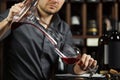 Sommelier pouring wine into glass from mixing bowl. Male waiter Royalty Free Stock Photo