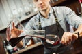 Sommelier pouring wine into glass from mixing bowl. Male waiter Royalty Free Stock Photo