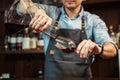 Sommelier pouring wine into glass from mixing bowl. Male waiter Royalty Free Stock Photo