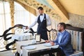 The sommelier pours the wine into the decanter near the guest in the restaurant. Royalty Free Stock Photo