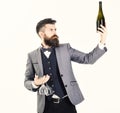 Sommelier with serious face proposes drink. Sommelier with elegant suit, bow tie and handsome face. Mature man holds Royalty Free Stock Photo