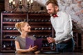 Sommelier with young woman on degustation in the