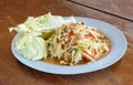 SomTam, Green papaya salad Thai cuisine spicy delicious on wooden plate with copy space