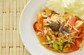 Somtum Thai spicy green papaya with black pickled crab salad on dish Royalty Free Stock Photo