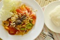 Somtum Thai spicy green papaya and black pickled crab salad eat with sticky rice Royalty Free Stock Photo