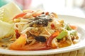 Somtum Thai spicy green papaya with black pickled crab salad on plate Royalty Free Stock Photo