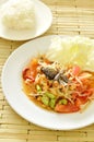 Somtum Thai spicy green papaya and black pickled crab salad with sticky rice Royalty Free Stock Photo