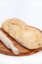 Somun bun and a rolling pin on a wooden board Royalty Free Stock Photo