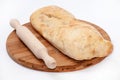 Somun bun and a rolling pin on a wooden board Royalty Free Stock Photo