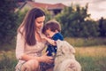 Son being licked by a dog while in mothers arms Royalty Free Stock Photo