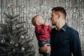 Son and dad. A little boy in the arms of his father at the Christmas tree Royalty Free Stock Photo