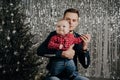 Son and dad. A little boy in the arms of his father at the Christmas tree Royalty Free Stock Photo