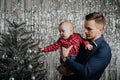 Son and dad. A little boy in the arms of his father at the Christmas tree Royalty Free Stock Photo