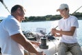 Son and dad yachting and looking happy and contented