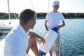 Son and dad yachting and looking happy and contented