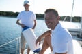 Son and dad yachting and looking happy and contented
