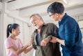 Son and daughter help support a senior father have a backache, Back pain in elderly adults, Asian family concepts Royalty Free Stock Photo