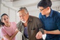 Son and daughter help support a senior father have a backache, Back pain in elderly adults, Asian family concepts Royalty Free Stock Photo