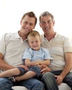 Son, father and grandfather sitting on sofa