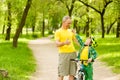 Son and father having fun riding a bike Royalty Free Stock Photo