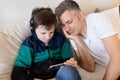 Son and father playing game on smartphone Royalty Free Stock Photo