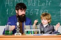 Son and father at school. small boy with teacher man. training room with blackboard. Flask in scientist hand with Test
