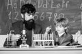 Son and father at school. small boy with teacher man. training room with blackboard. Flask in scientist hand with Test