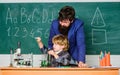 Son and father at school. small boy with teacher man. Wisdom. Back to school. Pharmacy and chemistry theme. solution in Royalty Free Stock Photo