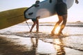 Son and father surfers run in ocean waves with surfing boards Royalty Free Stock Photo